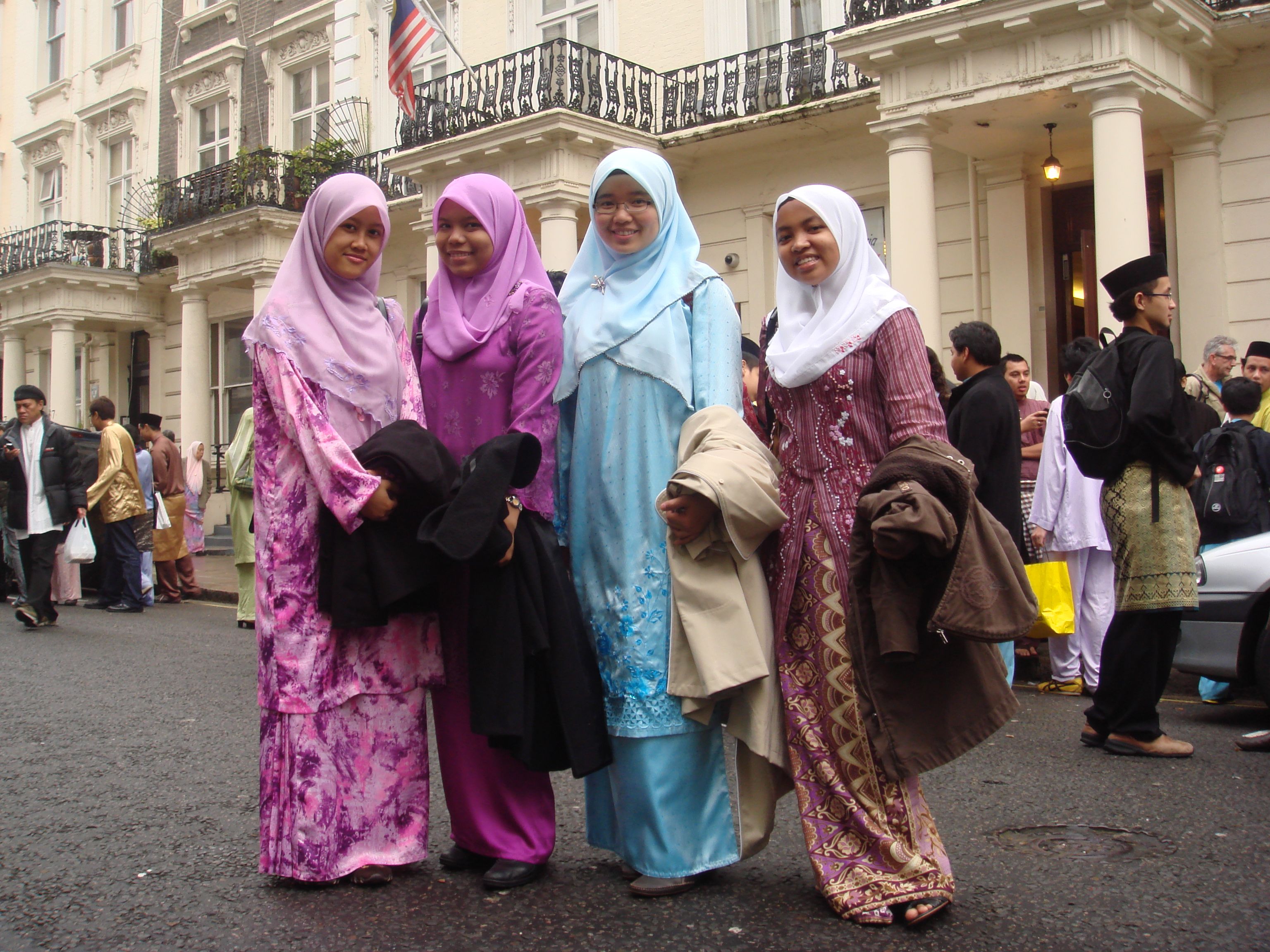 A group of four girls in traditional Malay clothing and headscarves