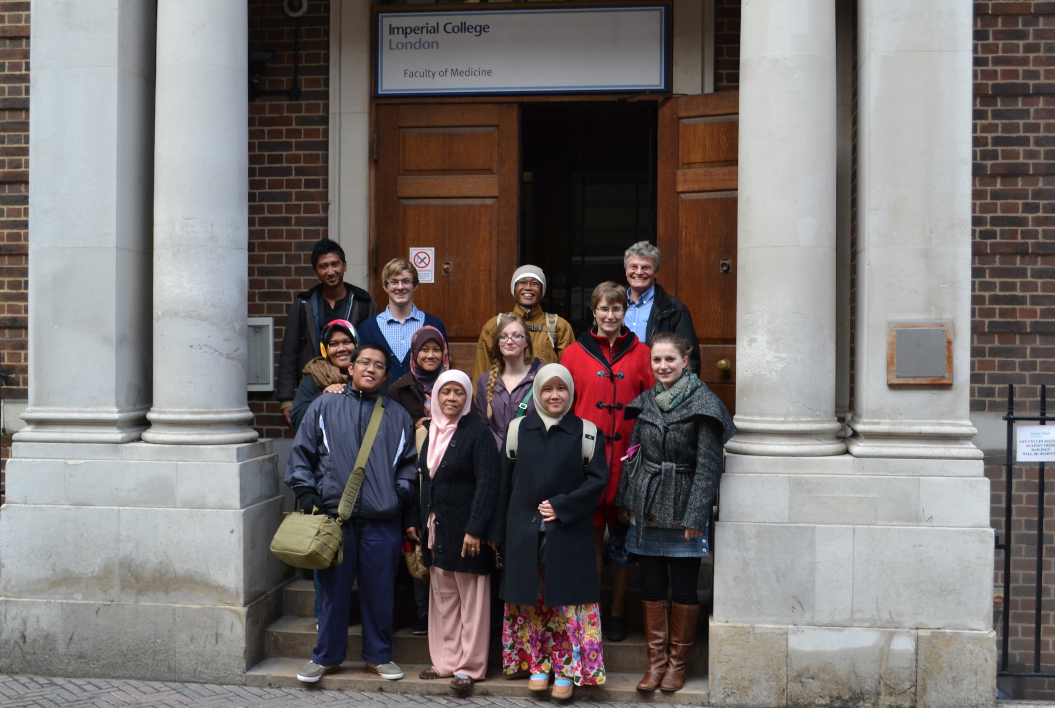 Group photo on steps outside some large wooden doors