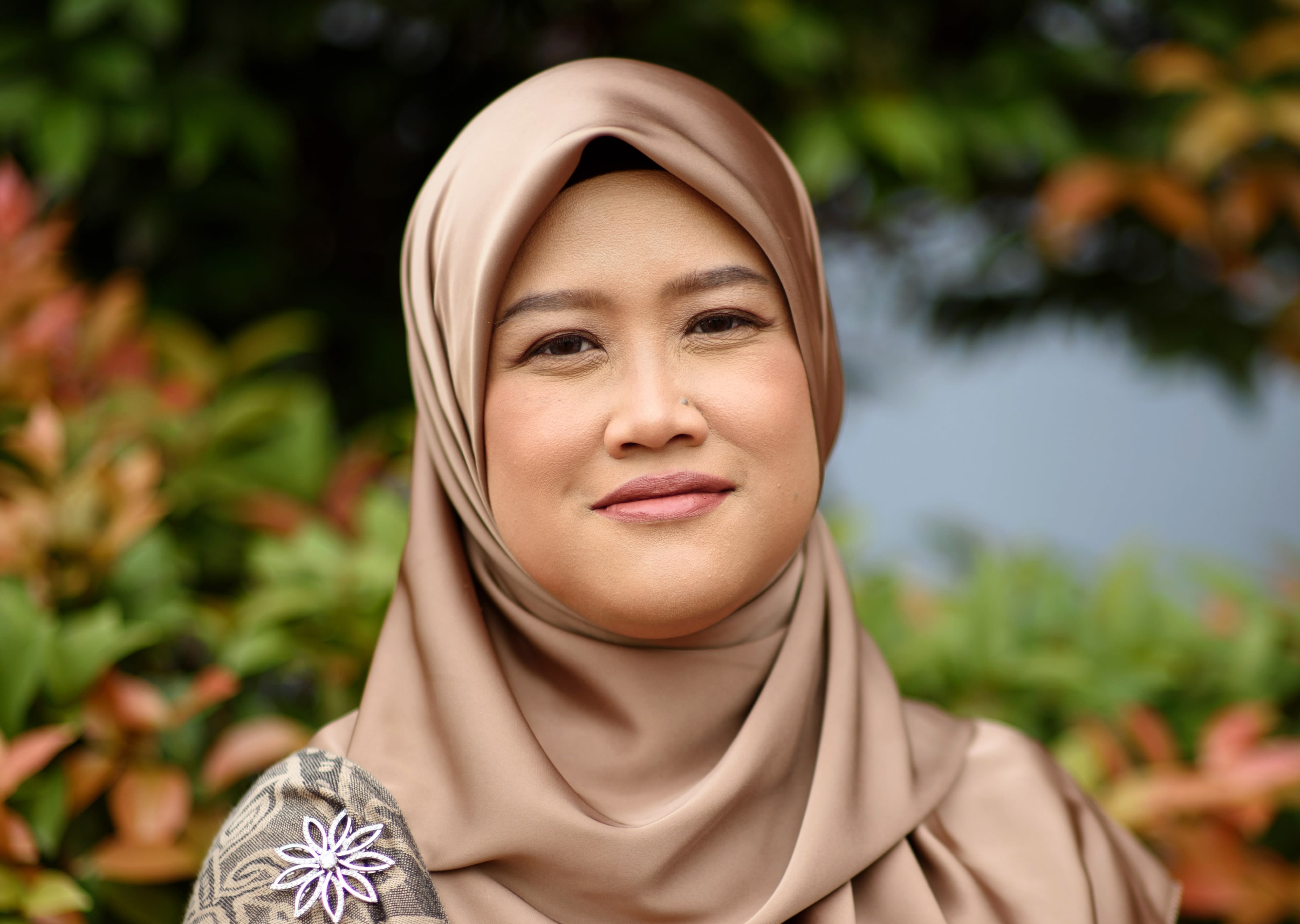 Dr Mariatulqabtiah Abdul Razak wearing a gold headscarf