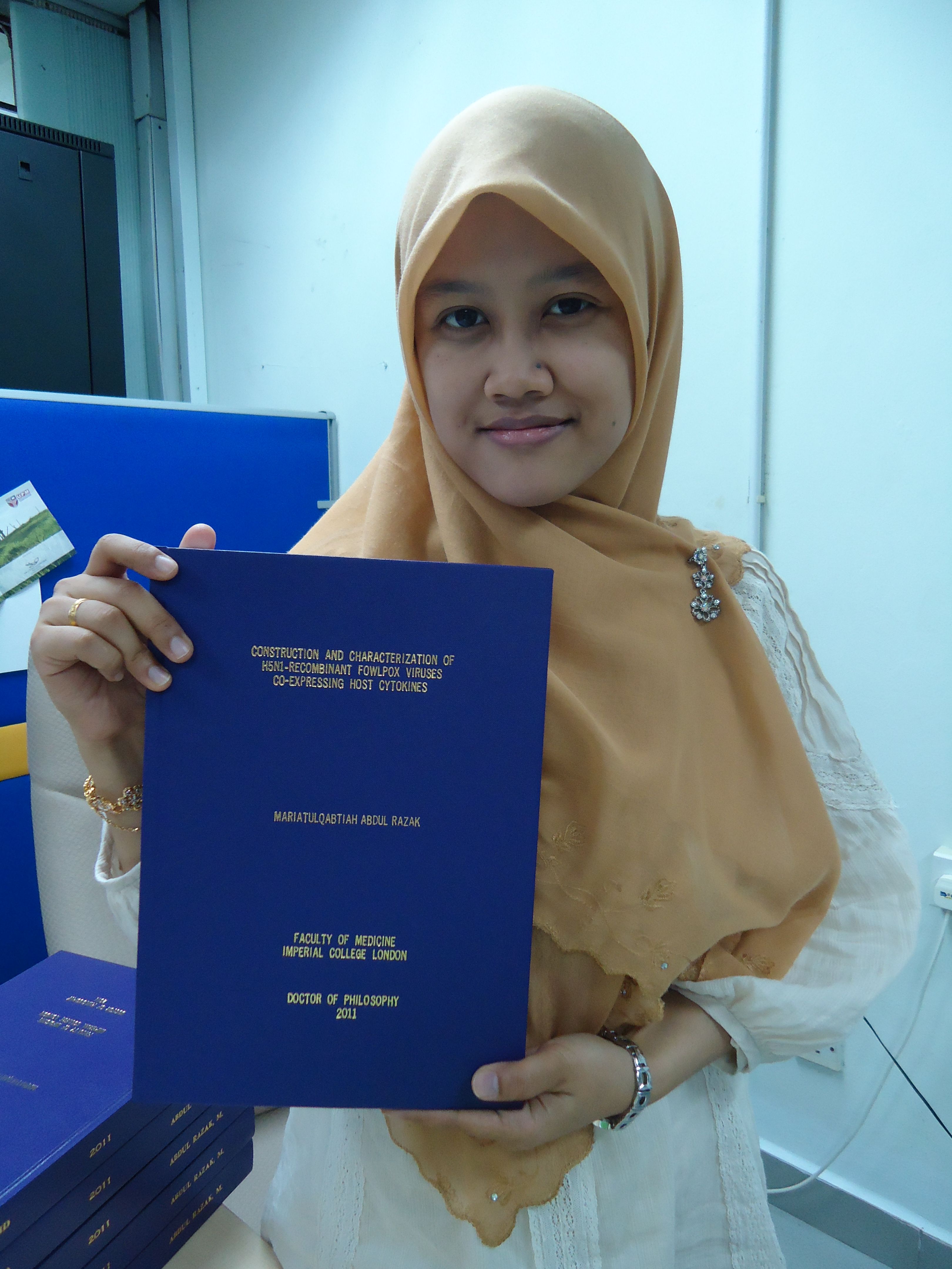 Maria with a copy of her PhD thesis