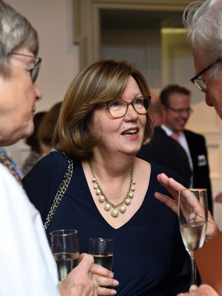 Guests talking at the Queen's Tower Society celebration event