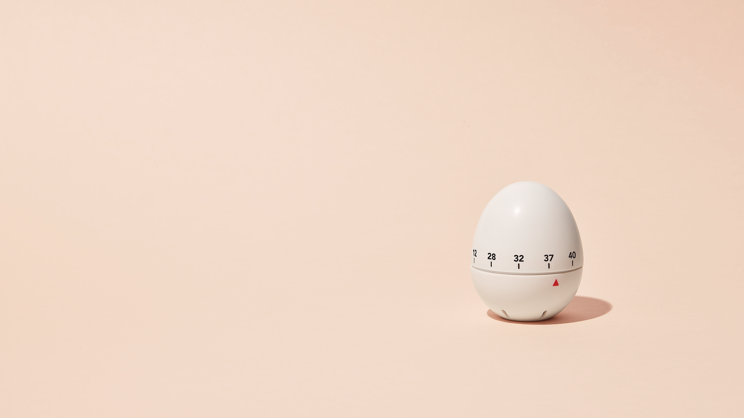 An egg timer on a beige background with the timer arrow at 37.5