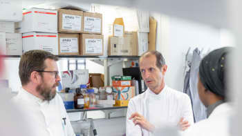 Two scientists talking in a laboratory.