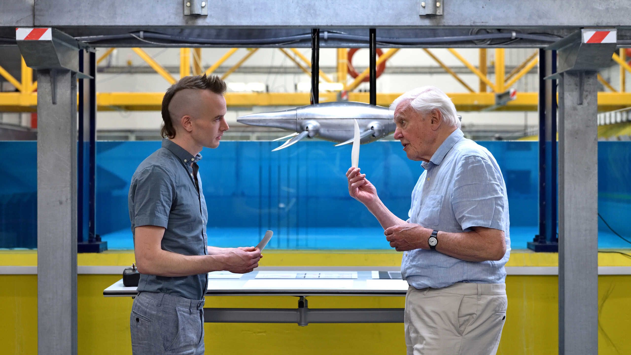 Sir David Attenborough and Luke Muscutt speak in front of Imperial's wave tanks