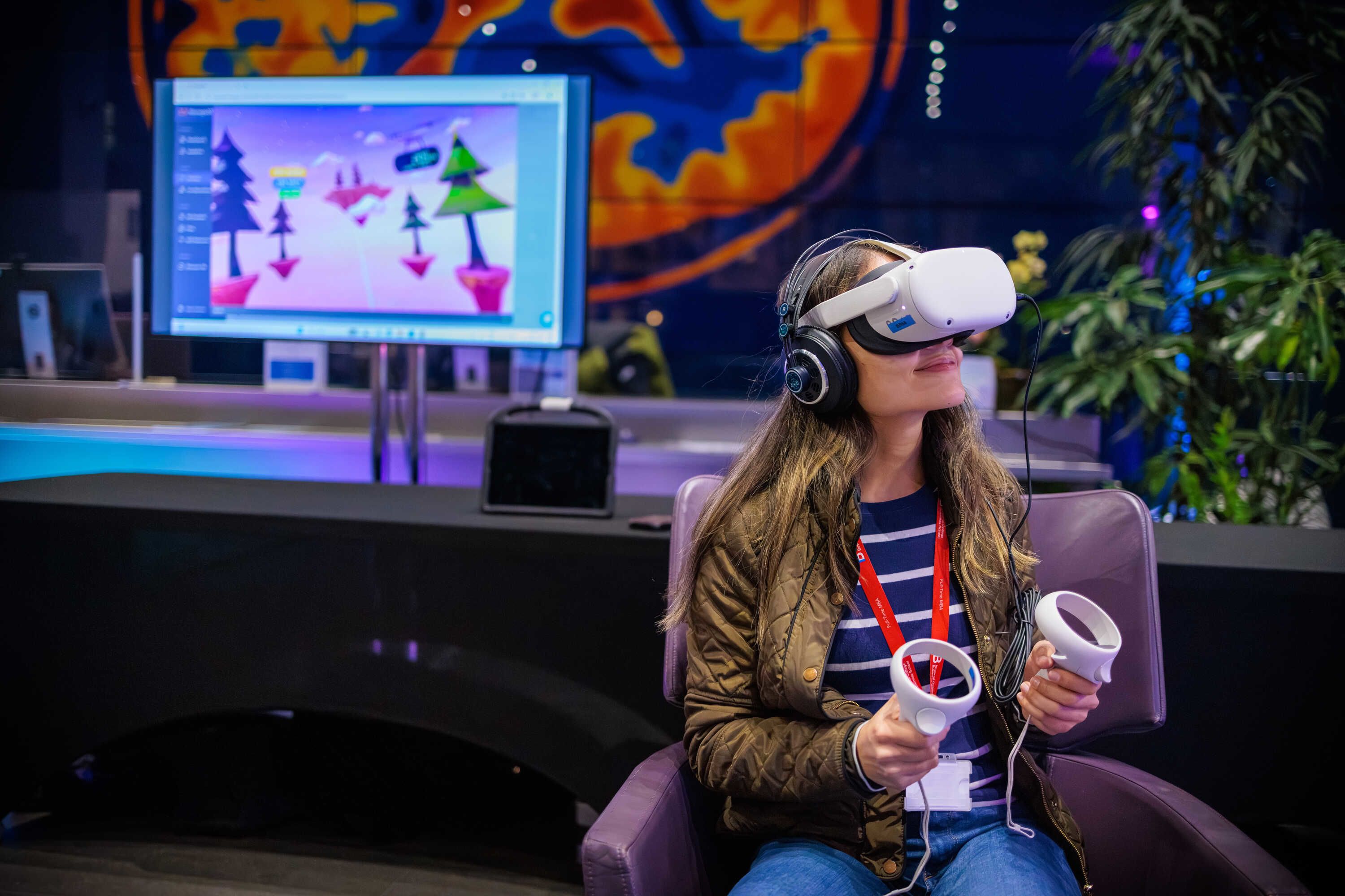A woman wearing a VR headset and smiling softly