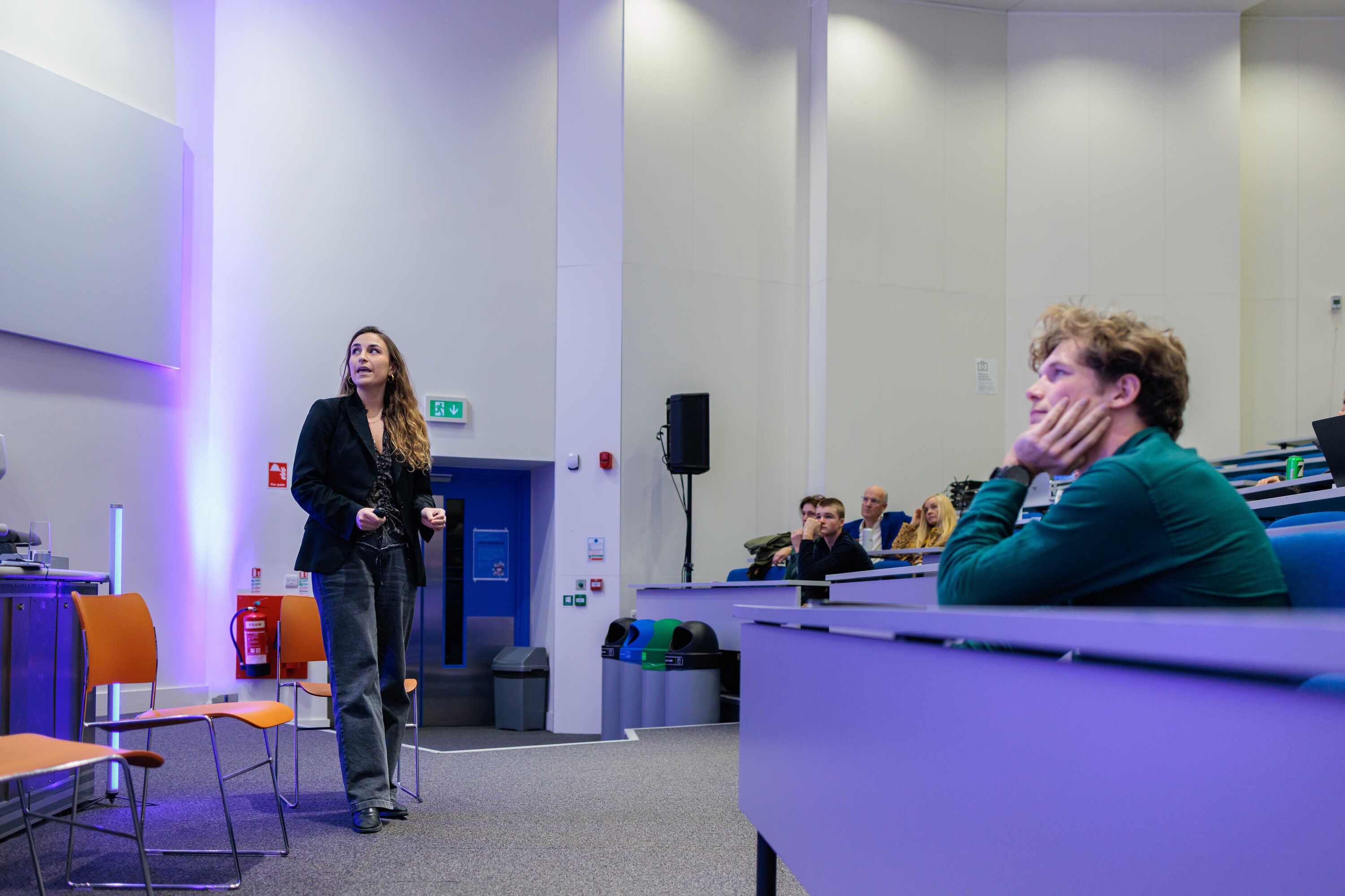 A speaker and an audience member at an Imperial Lates talk