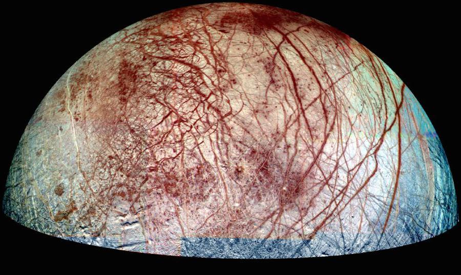 Image of the moon Europa, with blood-red scars across its icy surface