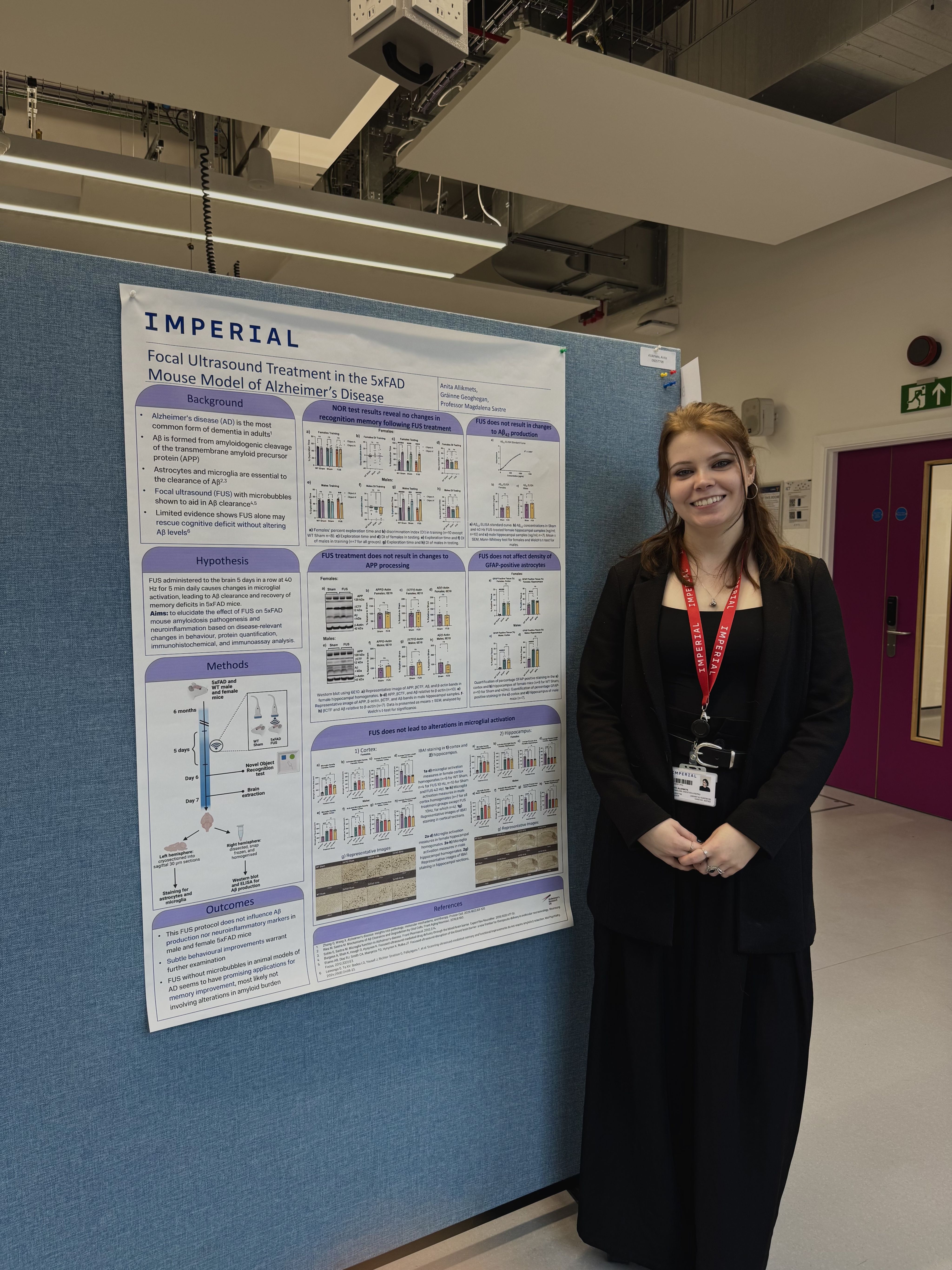 Anita stood next to a poster showing her research and work