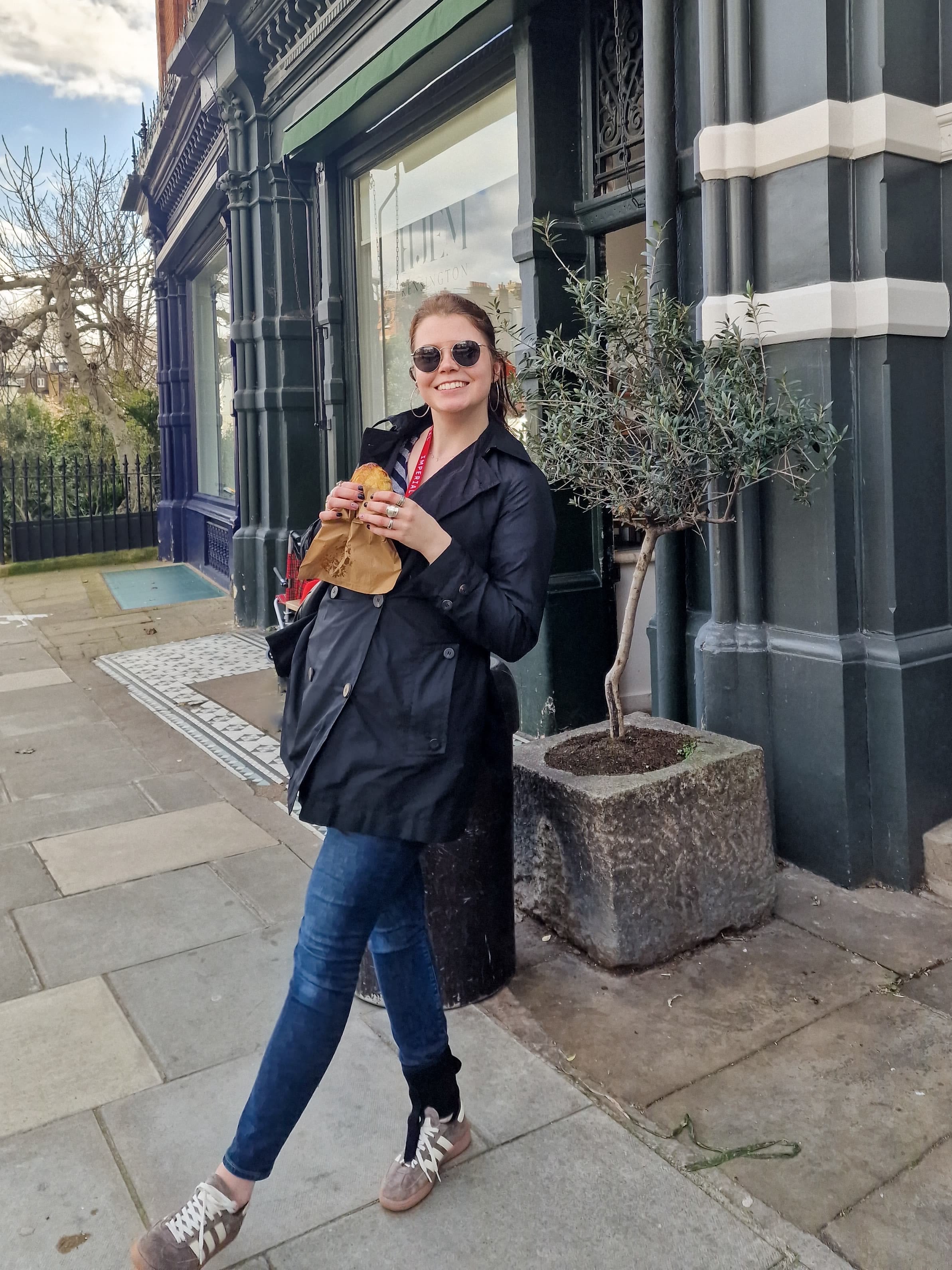 Anita out and about wearing sunglasses and holding a pastry