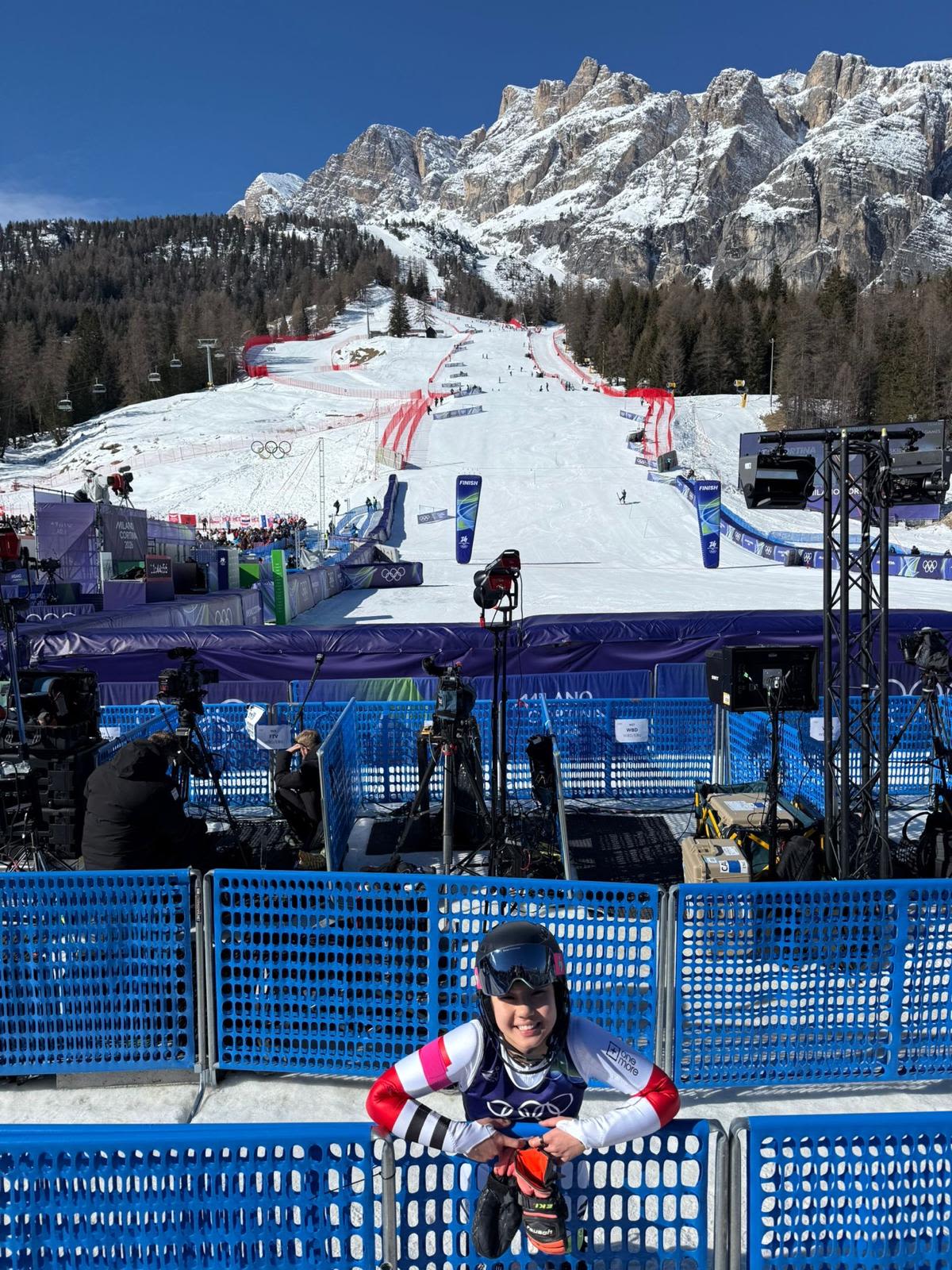 Eloise leaning against a barrier on the slopes