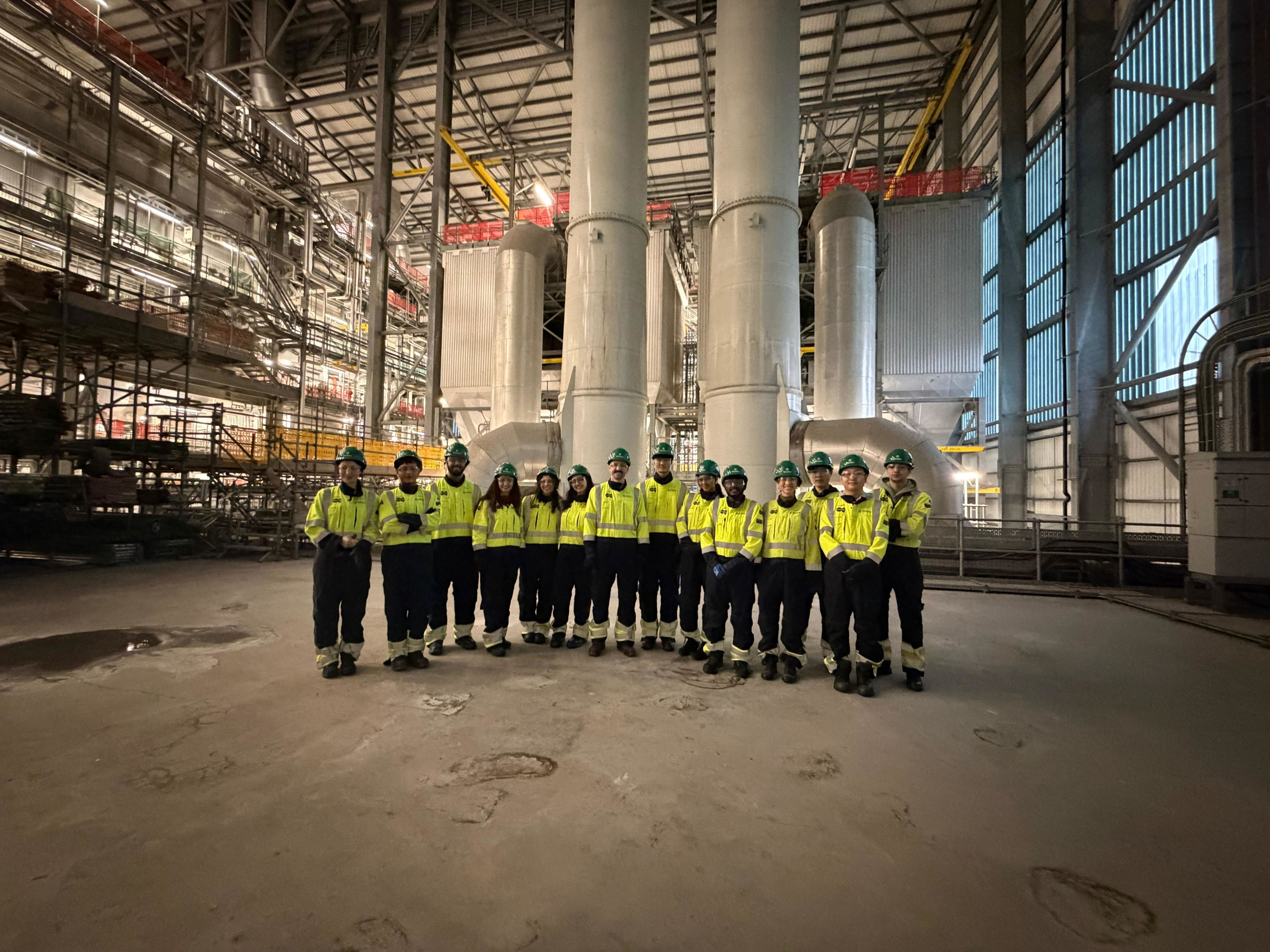 Emil with a group dressed up in PPE in a large warehouse facility