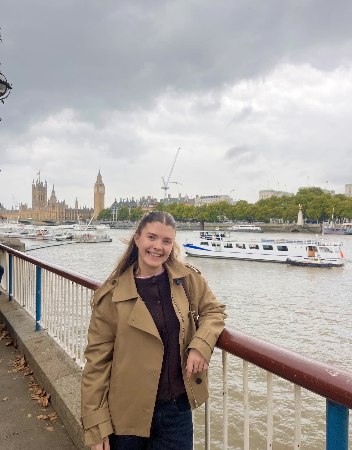 Hannah standing by the River Thames with Big Ben in the background