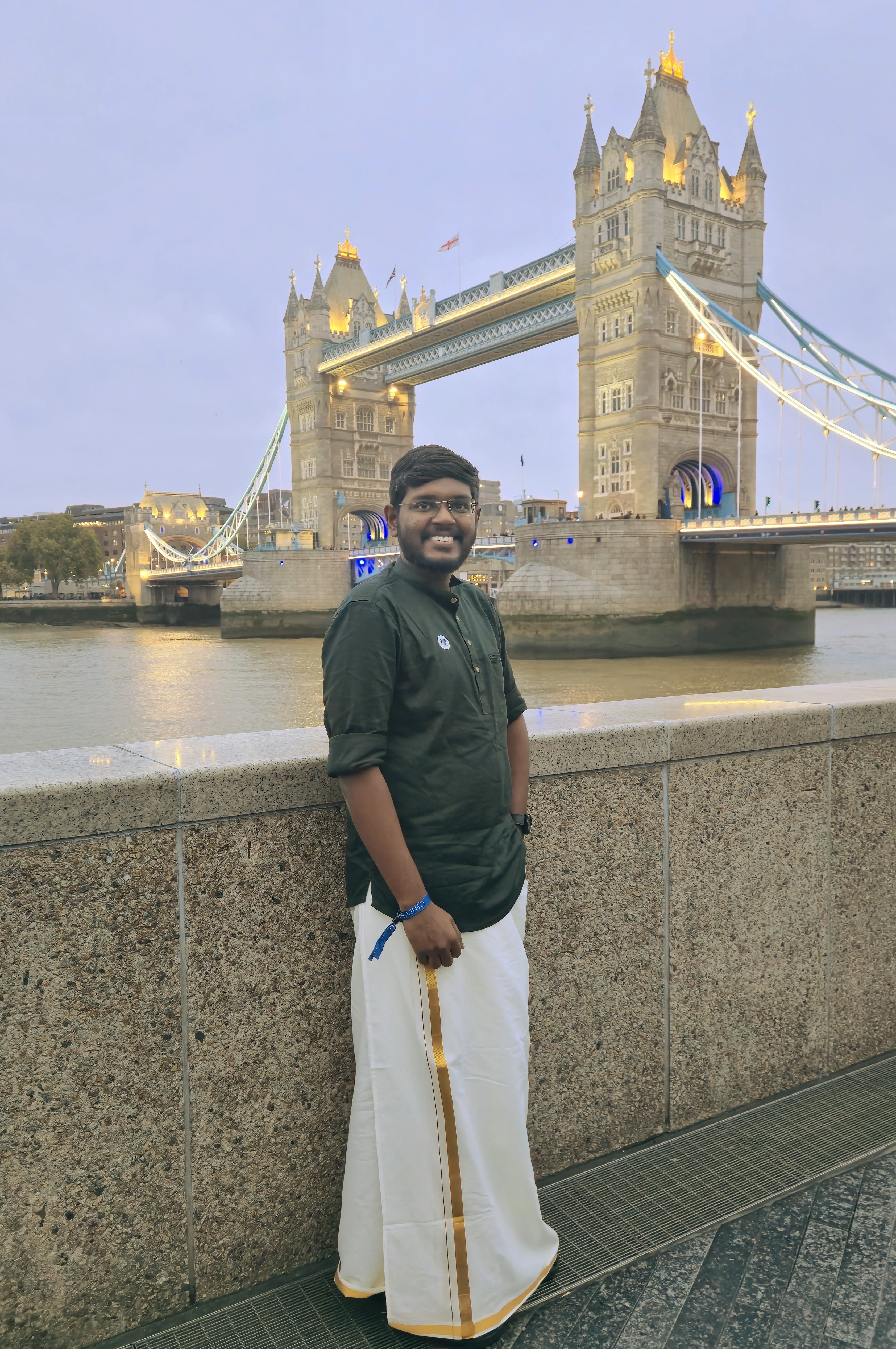 Janarthanan in London with the Tower Bridge behind him