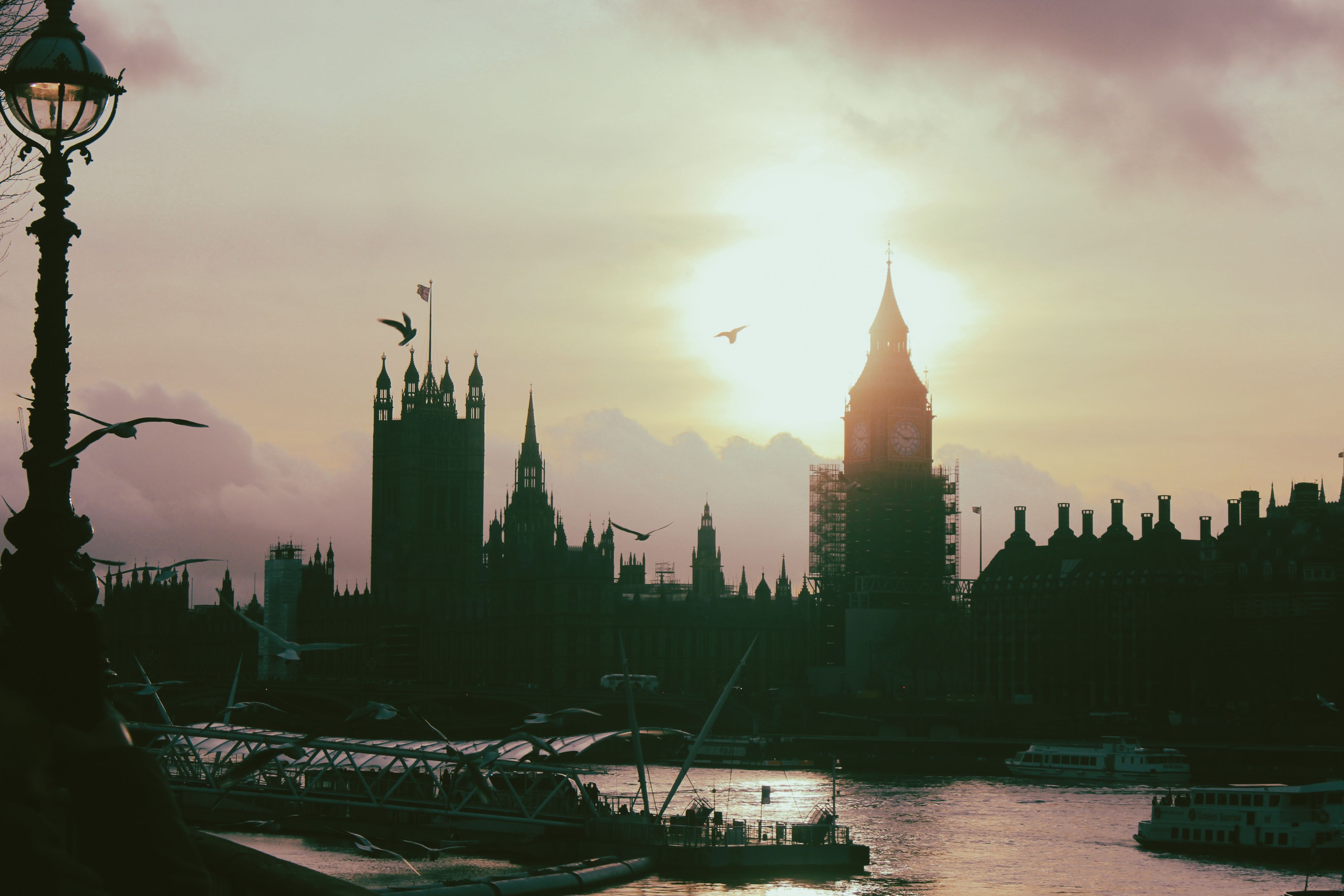 the sun is setting over the city of london