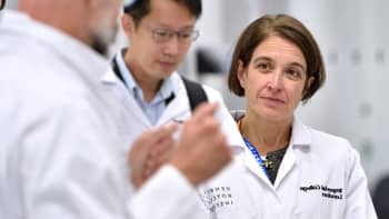 Professor Azra Ghani in a lab coat.