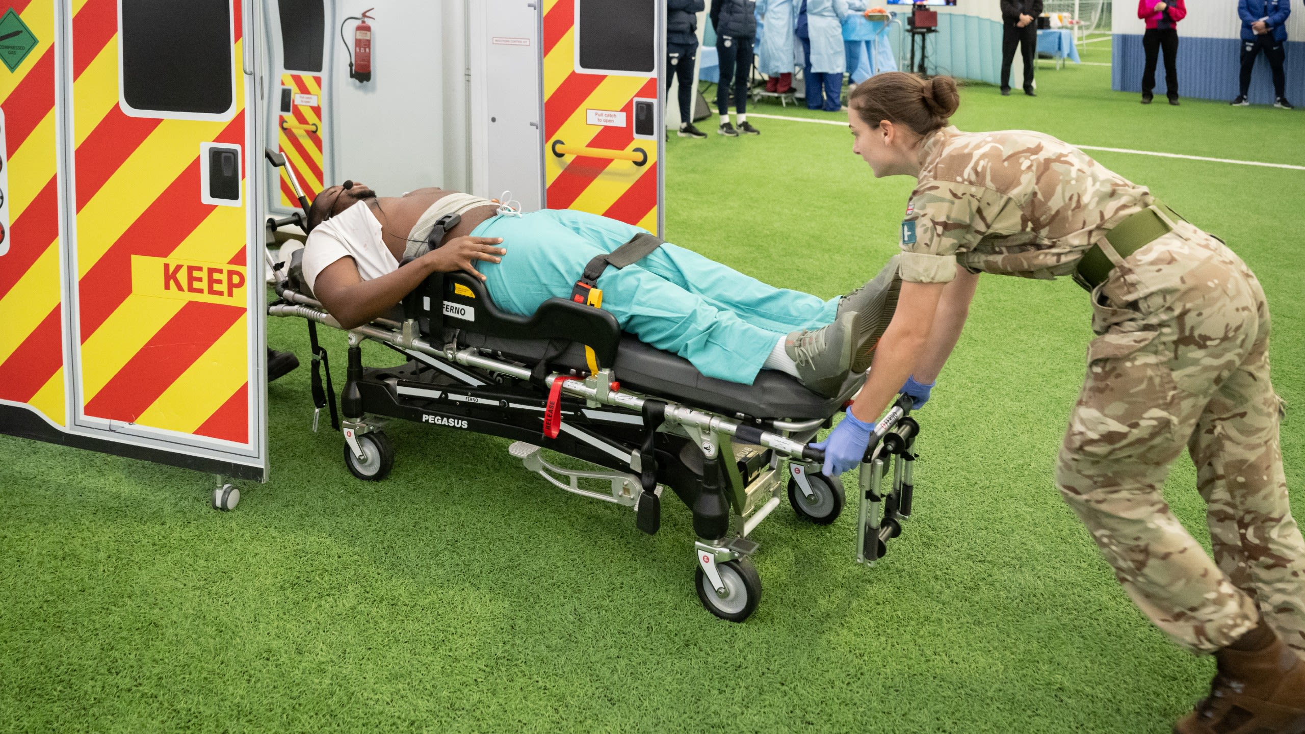 An actor is taken to an ambulance during the SHARP workshop.