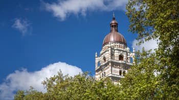 A tower with a copper coated domed roof.