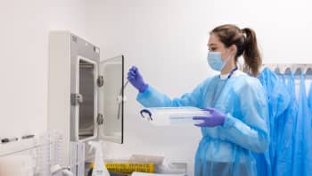 A technician working in Imperial's COVID-19 testing lab in 2021.