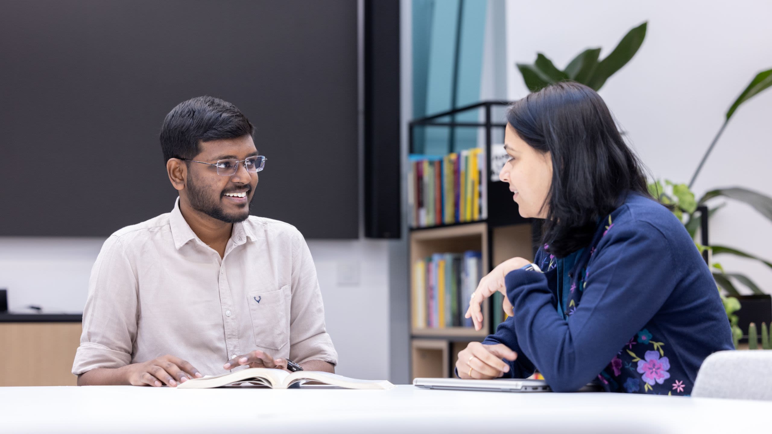 Jana sitting at a table chatting with Dr Rao