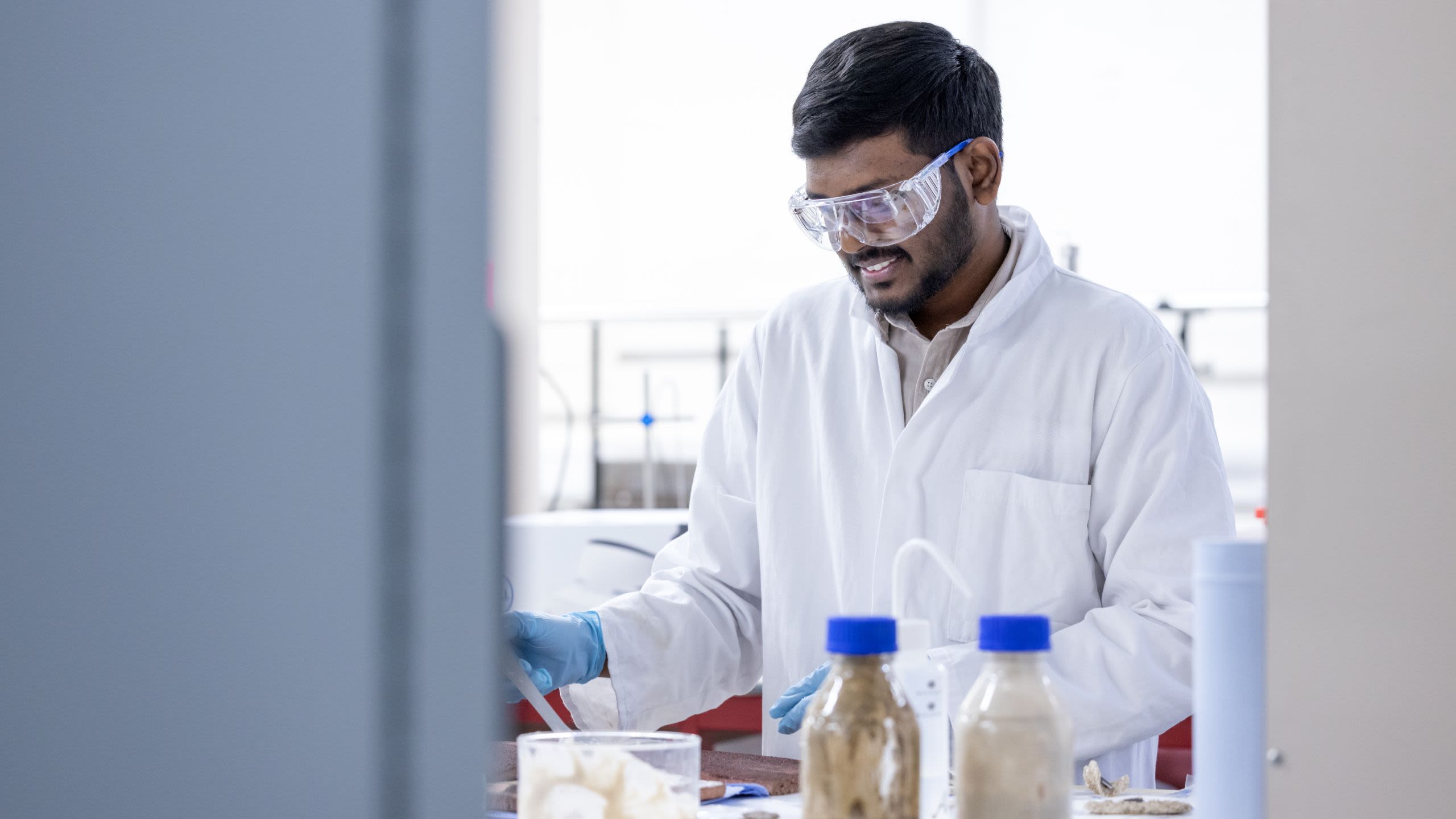 Jana wearing PPE and working in the lab