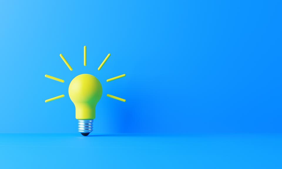 Yellow lightbulb on a blue background