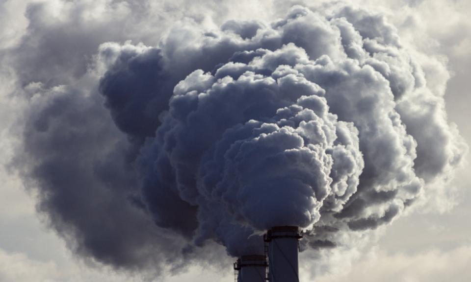 Smoke billowing out of chimney stacks