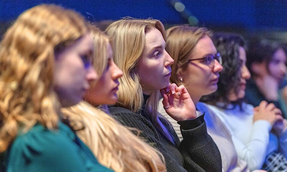 row of people sitting in a lecture theatre