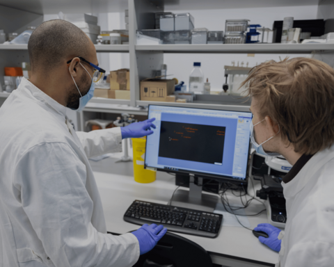 Two researchers in a lab looking at a computer screen