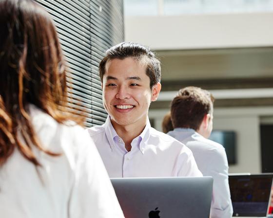 Smiling student interacting with a friend