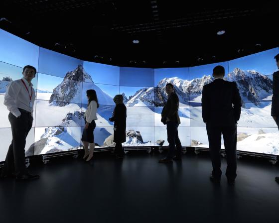 People standing in front of Analytics screen 