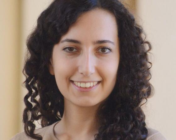 Headshot of a woman with curly hair standing in front of a beige background. Jasmin Moshfegh - New academic - 2025-26