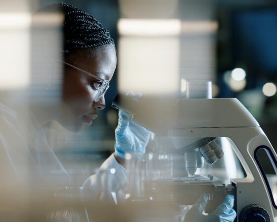  Scientist, microscope and analysis in lab for healthcare, innovation and development