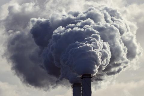 Smoke billowing out of chimney stacks