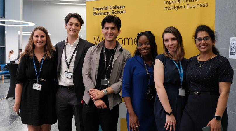 Group of MSc Finance & Accounting students posing together in front of an Imperial banner 