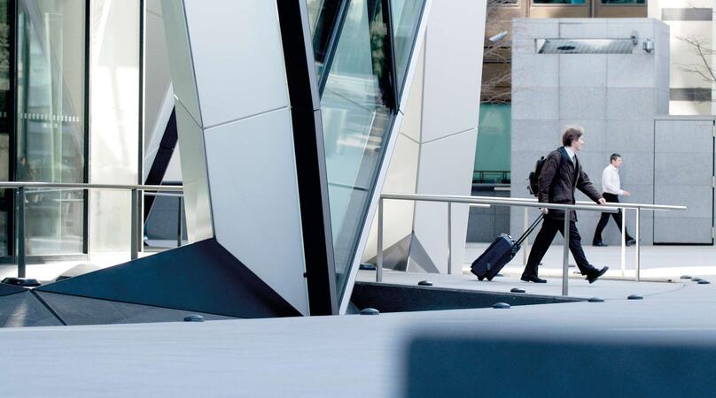 An abstract building with a view of two men in the distance 