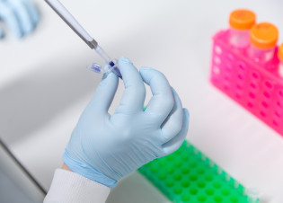 A researcher using a pipette