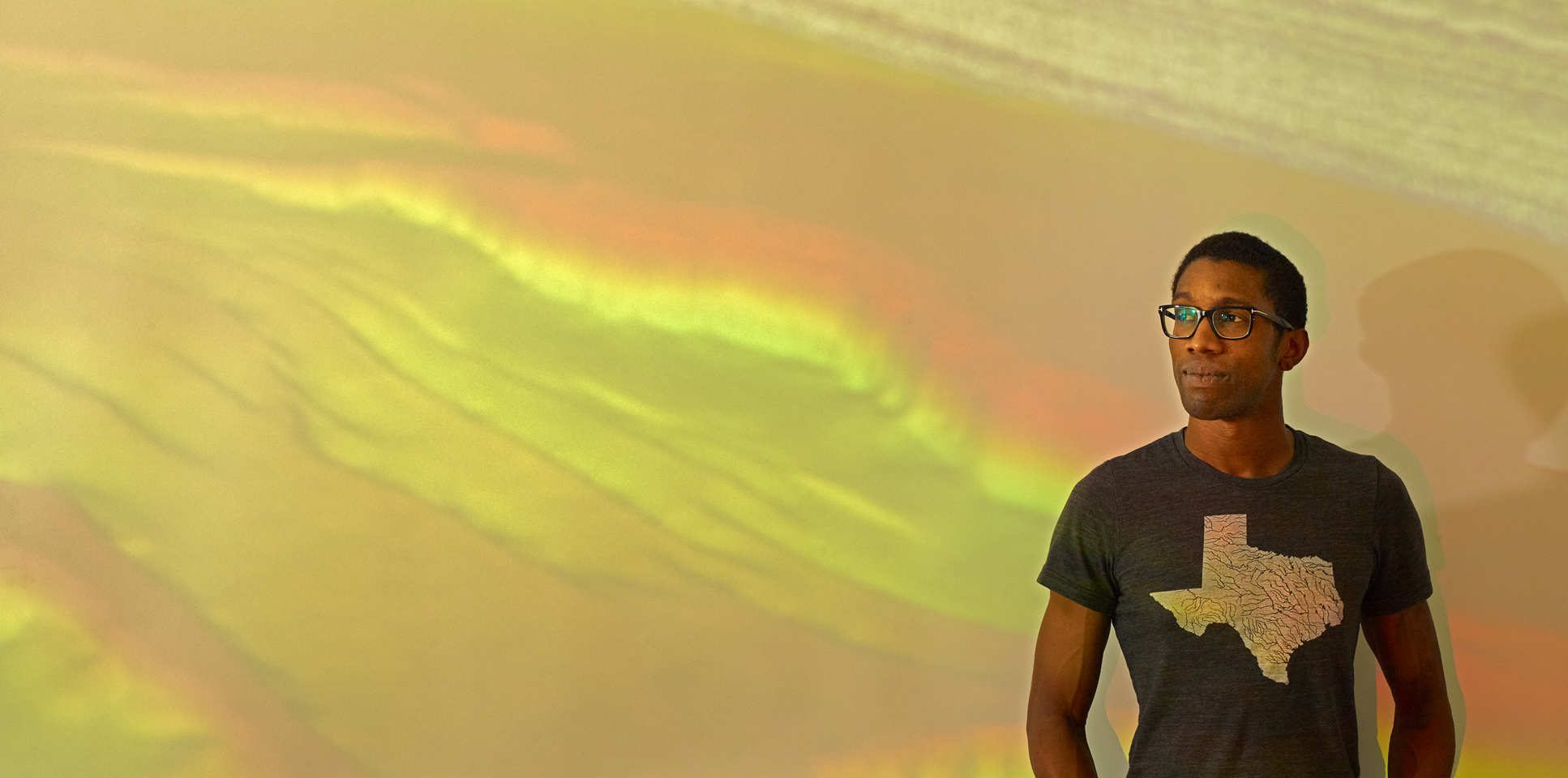 Professor Chris Jackson standing in front of a projection of seismic reflection data showing the subsurface structure of offshore North West Australia.