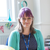 Dr Lizzie Day sits smiling at the camera