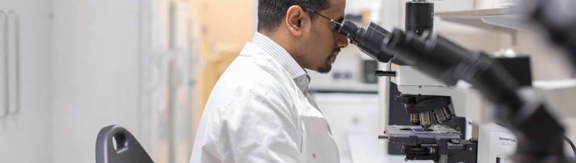 Man looking through microscope