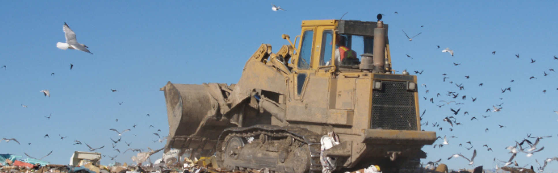 A digger on a landfill site