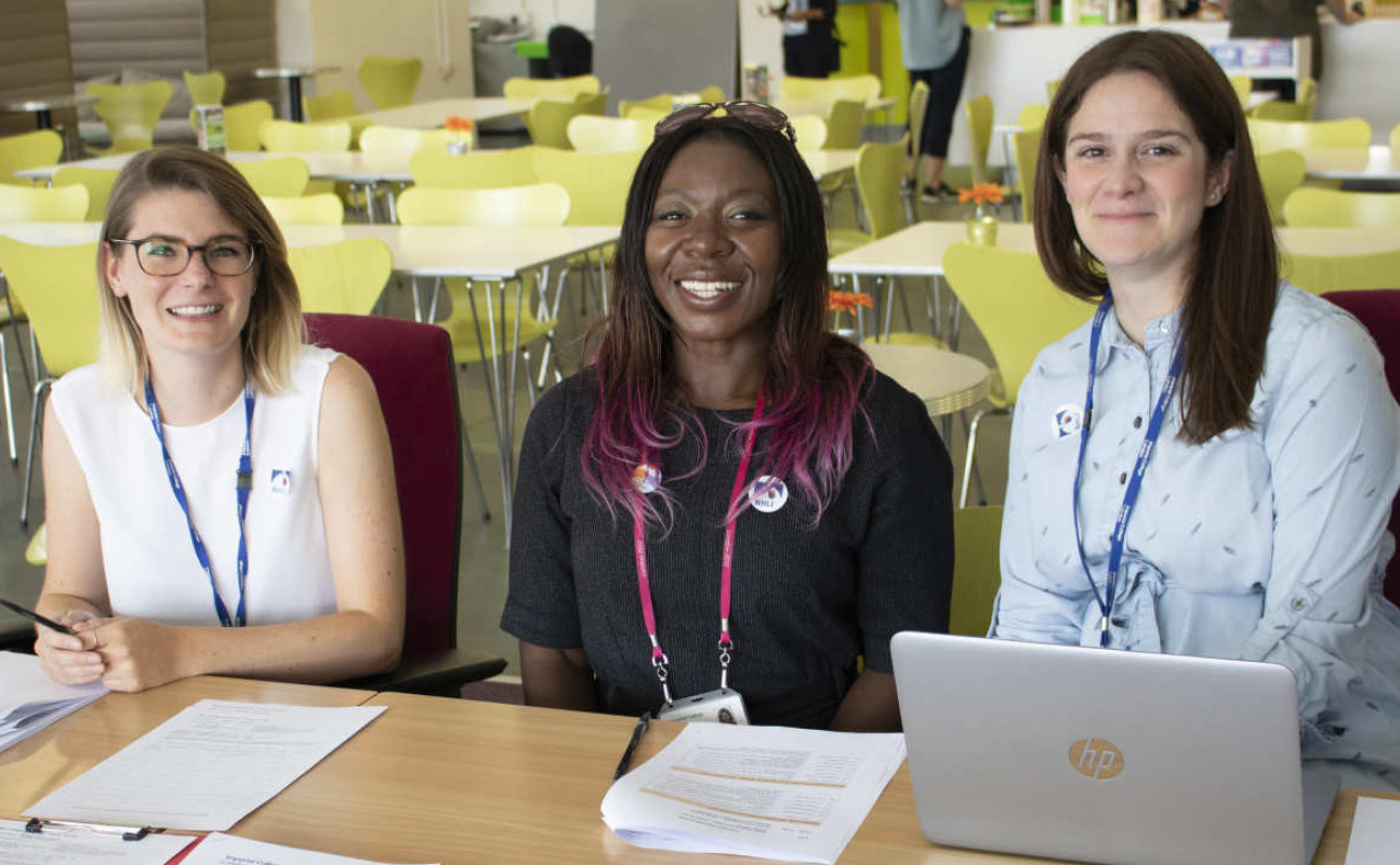 Eleanor with colleagues sits at table