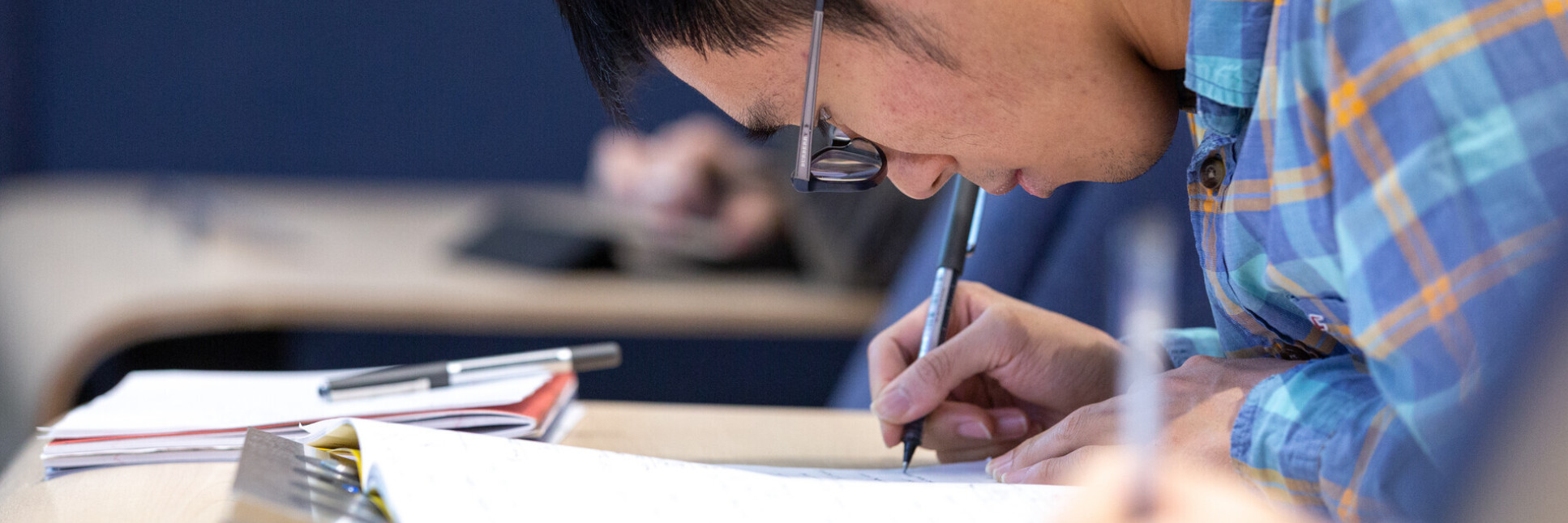 Male student taking notes