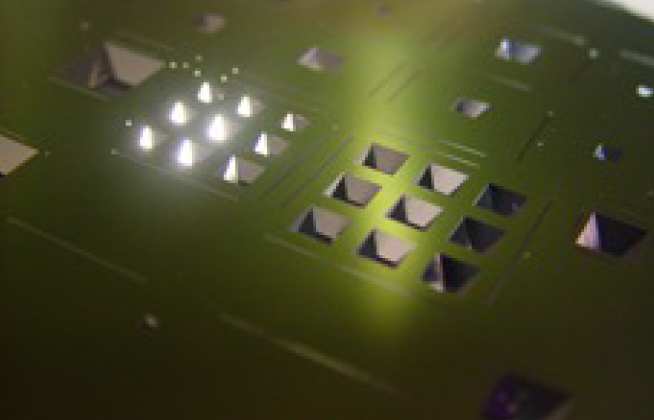 Pyramids etched in a silicon wafer by the process of anisotropic etching in KOH. We can etch pyramids from 10s of microns up to 4mm in size