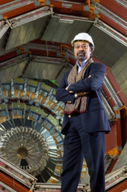 Professor Jim Virdee stands in front of the CMS particle detector during its contruction
