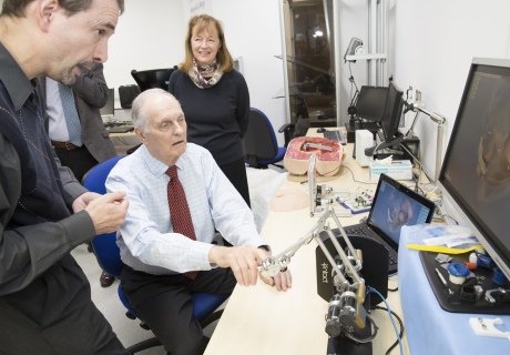 Alan Alda performs a robotic rectal exam