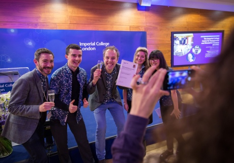 group of people in matching t shirts with certificate