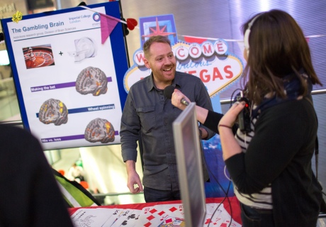 Man with a poster of brain scans