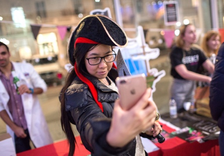 Woman taking a selfie in a pirate hat