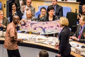 Kofi Nyarko and Dr Wendy Harrison presenting Dr Margaret Chan with award