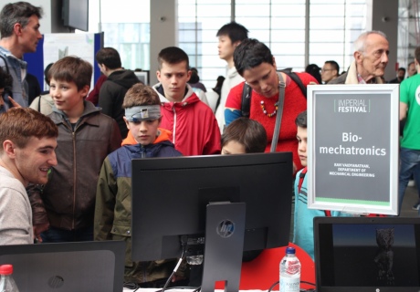 Children playing video games at the Biomechatronics lab display